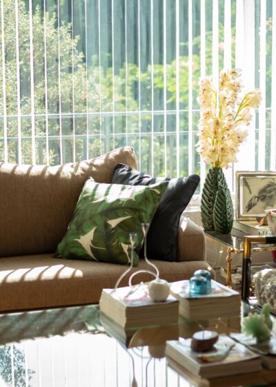 Interior of a modern living room with a glass table, stylish sofa, and decorative elements.